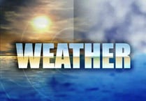 Met Office lifts the amber warning in the island while heavy snow falls in parts of England and Wales