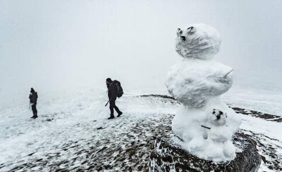 Picture: PA: A snow man on the trig point of Mam Tor in the Peak District National Park, as snow and freezing conditions continue to hit the UK