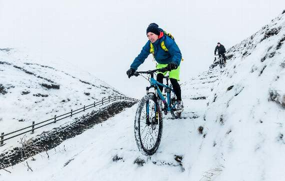 Cyclists near Mam Tor in the Peak District National Park, as snow and freezing conditions continue to hit the UK. PRESS ASSOCIATION