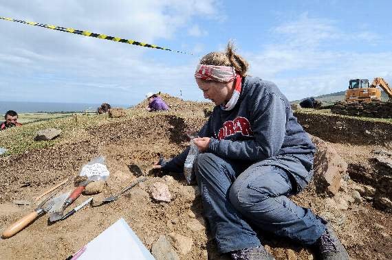 Osteoarcheaologist Dr Michelle Gamble examines the remains of a burial urn containing cremated human remains