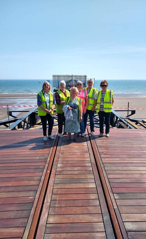 Members of the fundraising team walk on the pier for the first time