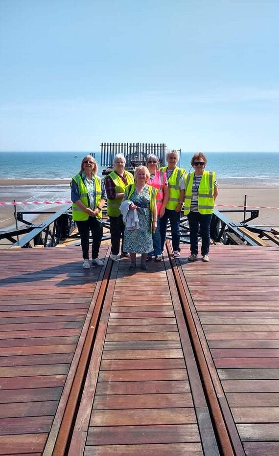 Members of the fundraising team walk on the pier for the first time