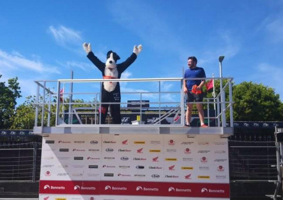 Jim Macgregor, or Manxie the Dog, celebrated finishing the course on top of the TT podium