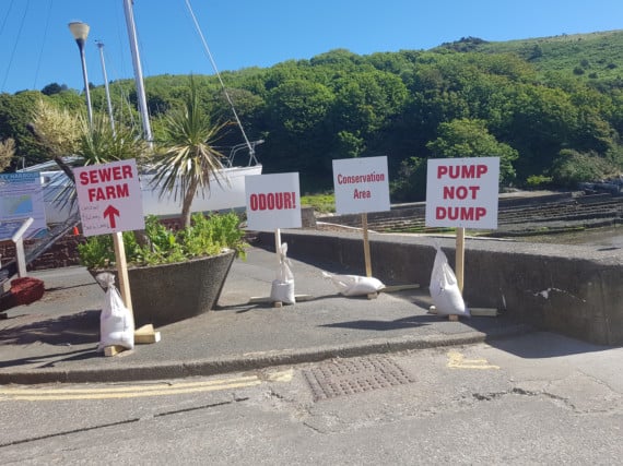 Signs opposing plans to erect new sewage treatment works in Laxey were spotted overlooking the proposed spot