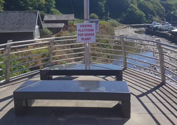 Signs opposing plans to erect new sewage treatment works in Laxey were spotted overlooking the proposed spot
