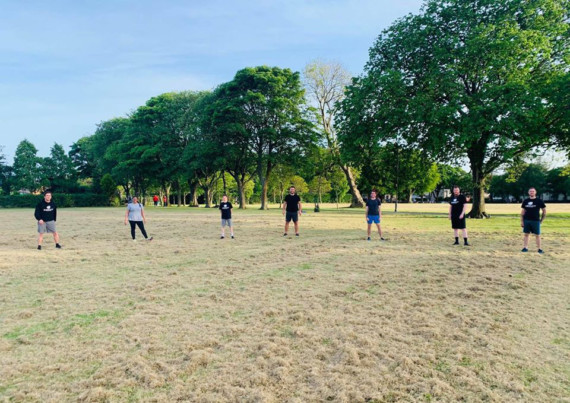 Members of Impact Kickboxing social distancing during an outdoor training session