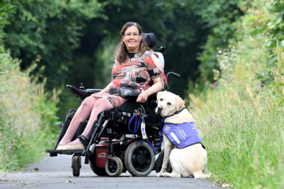 Miriam O'Boyle with assistance dog Nelson on the old railway line in Kirk Michael -