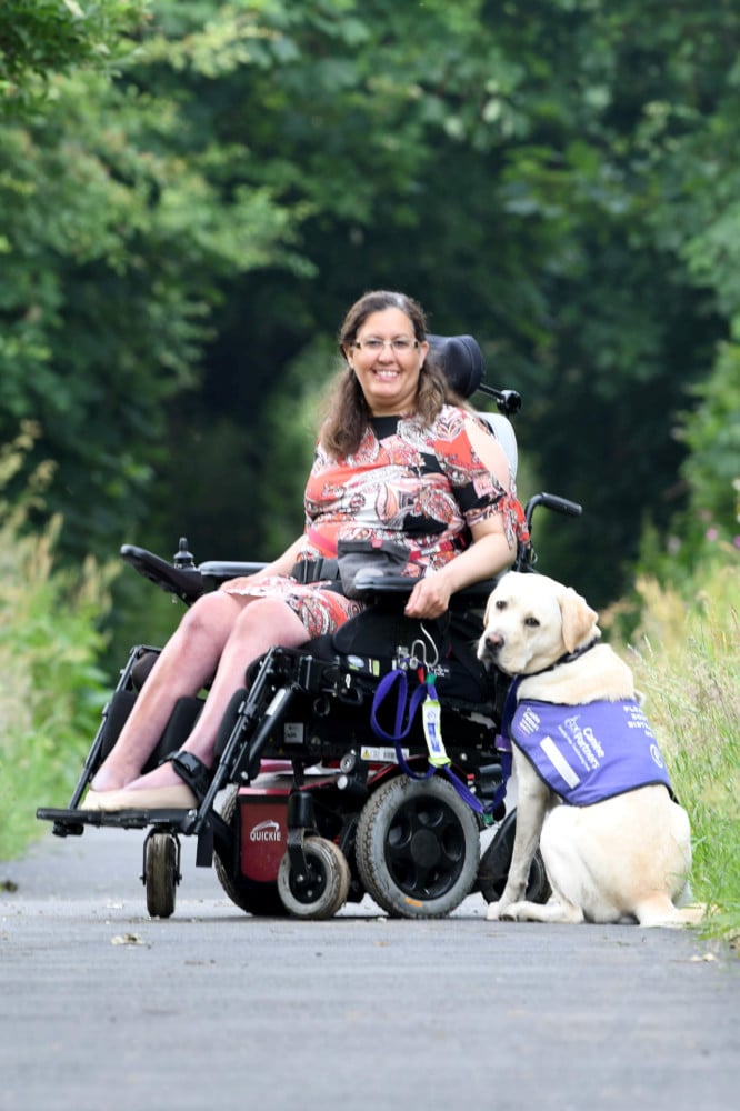 Miriam O'Boyle with assistance dog Nelson on the old railway line in Kirk Michael -