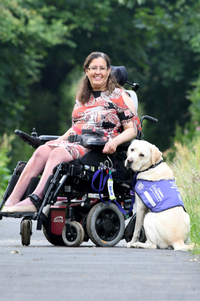 Miriam O'Boyle with assistance dog Nelson on the old railway line in Kirk Michael -