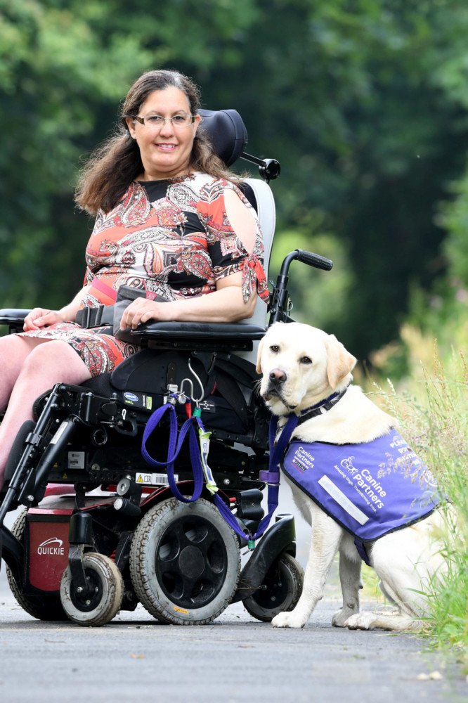 Miriam O'Boyle with assistance dog Nelson on the old railway line in Kirk Michael -
