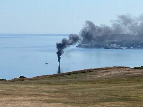 The boat on fire in the bay