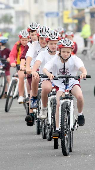 IN HOT PURSUIT: Teams of children take part in their own cycling races to celebrate the Tour of Britain coming to Teignmouth along the promenade on Tuesday. Picture Alan Craig