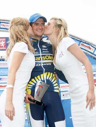 RIDING HIGH: Wout Poels, of Vacansoleil Pro Cycling Team, gets a kiss with his trophy as he crosses the line (right) to win Stage Four of the Tour of Britain. Picture Alan Craig