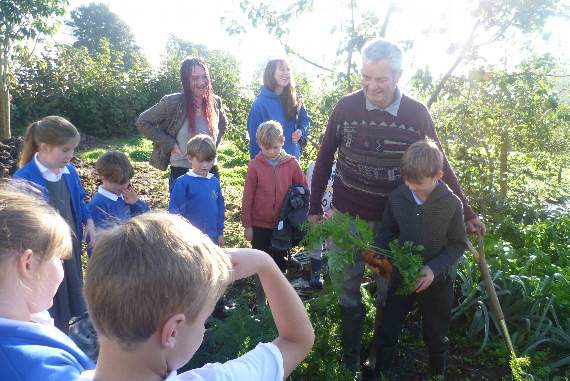 CARROT DIGGING: Pictured above is Hennock farmer Richard Harvey with some of the school children at Stickwick Farm.
