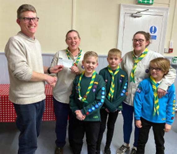 Sara Pitchford of Buckfastleigh Scout Group and friends receive £440 for their work. Making the presentations was town mayor Andy Stokes.