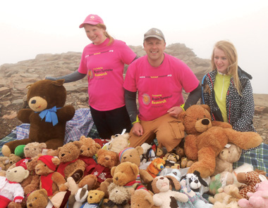 Emma Welch (right) pictured with Andrew Stammers, who inspired her fundraising efforts, at the top of Snowdon with her unconfirmed record-breaking number of teddies in aid of Brain Tumour Research.
