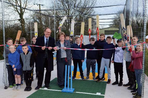 Jacqui Nolan, the Child Welfare Officer for Chilcompton Sports Cricket Club and Winston Dugied, a Non-Executive Director of the Somerset Cricket Board, cut a ribbon to officially open the new nets, watched by young members of the club. Photo: Will Nicol