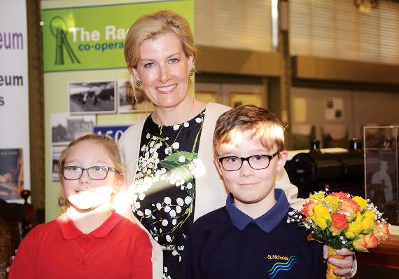 HRH is presented with flowers by Tayla and Michael.