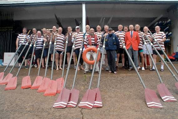 The Monmouth School crews from 1969 and 1976. John Hartland is pictured with the crews (wearing a red jacket)