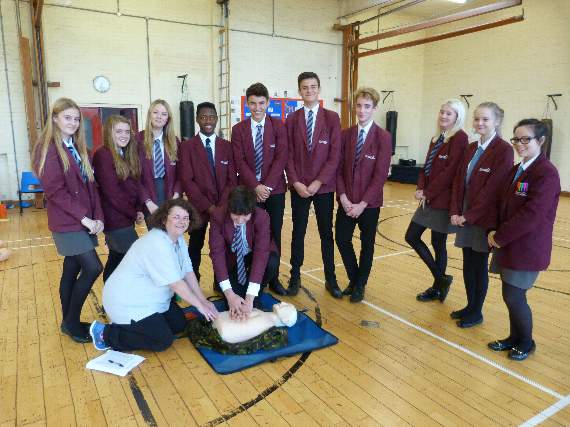 Pupils undergoing defibrillator training