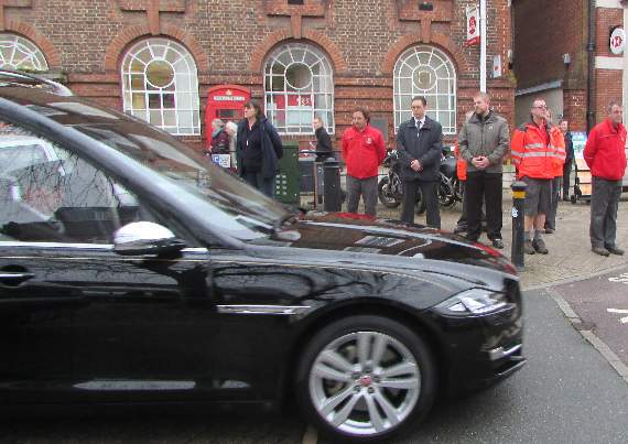 The hearse carrying former postman Adrian Russell stops outside Petersfield Post Office so colleagues could pay their respects