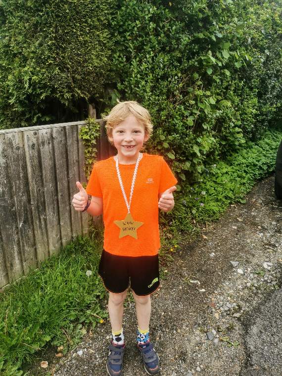 Henry celebrating finishing his marathon