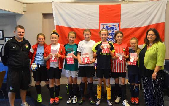 The Ross Juniors Under 10 Girls with their coach, Carl Roberts, and Town Councillor, Hannah Lerego