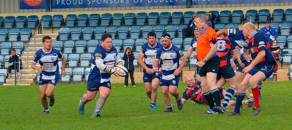 Prop Jonny Baynham draws in defenders and offloads ball.
