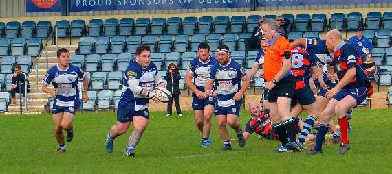 Prop Jonny Baynham draws in defenders and offloads ball.