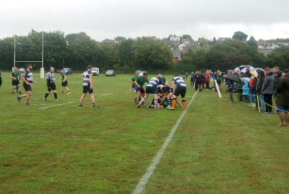 Watching the rugby match in driving rain