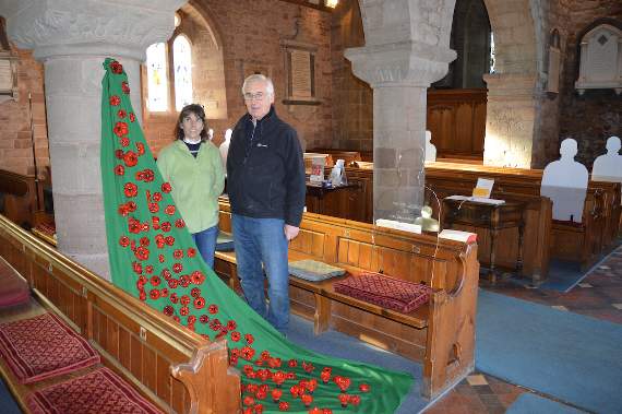 Rob and Debs with the poppies and silhouettes in Weston under Penyard Church