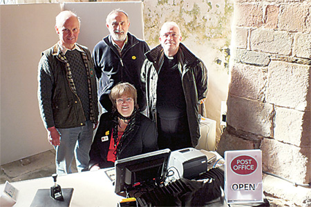 Jeremy Wells, Tom Holway, Tina Debenham and Harry Jevons at the post office counter