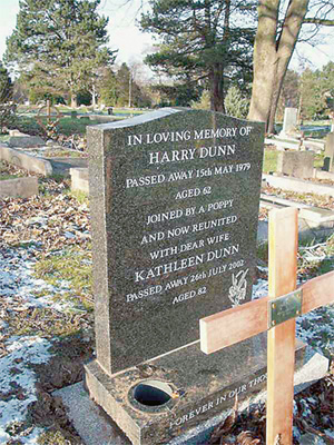 The headstone that marks their grave, bearing the words ‘Joined by a poppy and now reunited’