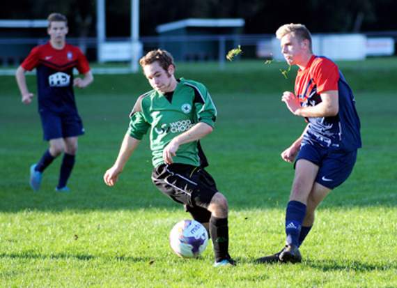An Ivybridge player forces a Stoke Gabriel defender into a hurried clearance