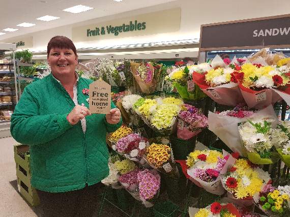 Sally Jarvis, Morrisons Community Champion with the label that will be attached to the flowers