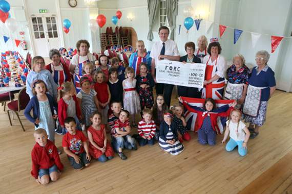 Salcomb Beehives, Brownies and Rainbows present a cheque to Clive Parsons (chair) and Jan Carter from the Friends of Redfern Health Centre
