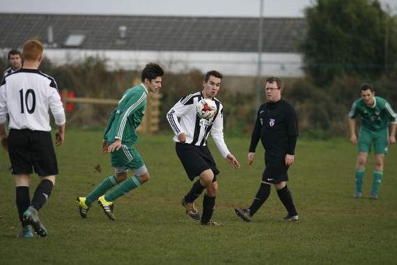 K and K's Alex Thomas looks to control the ball