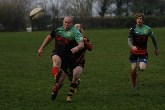 John Dingle kicks the ball forward
