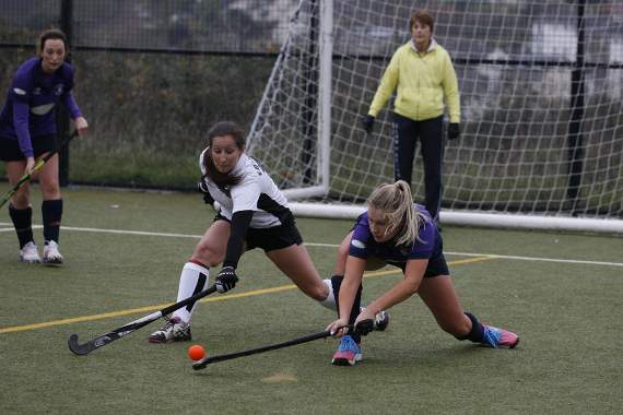 Dartmouth's Jamie Rendle-Streeter clears under pressure from Dart's Siobhan Edwards