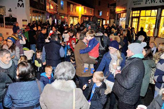 Families and friends gather to enjoy the traditional switching on of Salcombe's Christmas lights