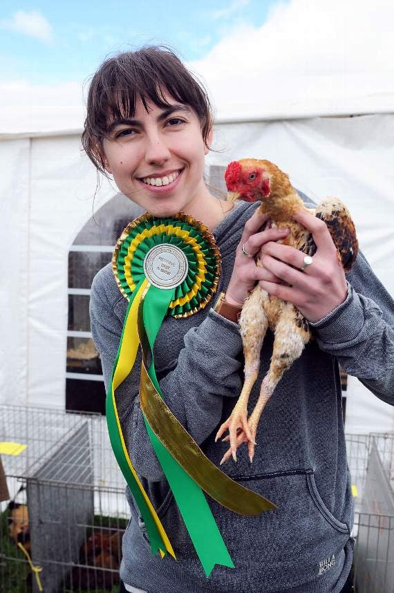Sophia White holds James Eggin's Koshamo cockerel, who made reserve 'best bird in show'