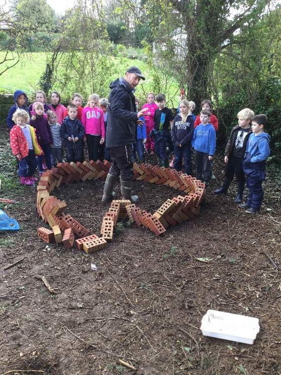 Pupils building an African keyhole garden at Aveton Gifford Primary School