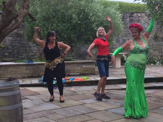 Volunteers practice their belly dancing with Ruby Azar, AKA Alison Theaker