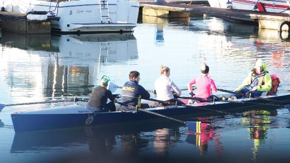Sophie Harris, centre, wearing light-coloured top, with the Mayflower Offshore Rowing Club in Plymouth