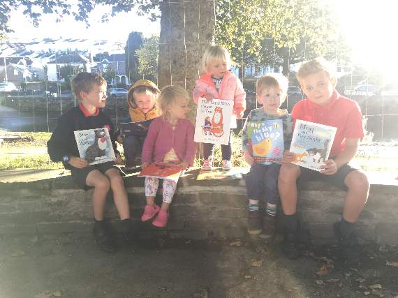 The boys and girls of Happy Ducks childminding beside the quay before sending their books away