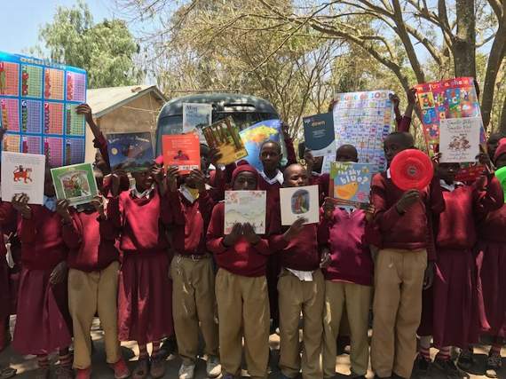The children of Le Manyatta happily holding their books