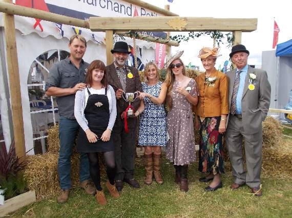 Show chair Apple Taylor and Show president Jo Lapthorn present South Hams Fencing and Marchand Petit Best Show Stand