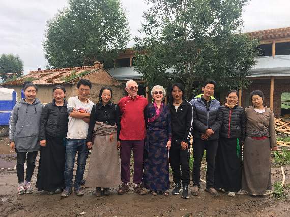 Malcolm and Amanda with the Tibetan family outside the craft centre-to-be