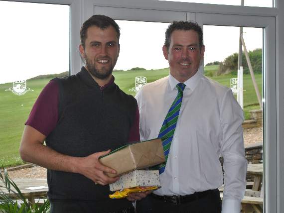 Jack Wallace left receives his leaving present from Thurlestone professional Steve White