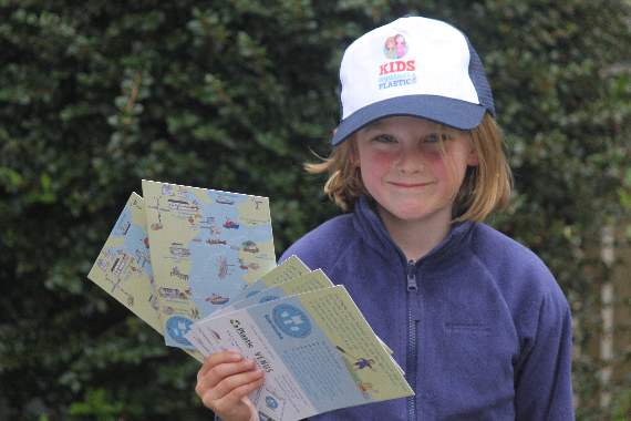 Six-year-old Ella Turns holds their new Plastic Clever maps